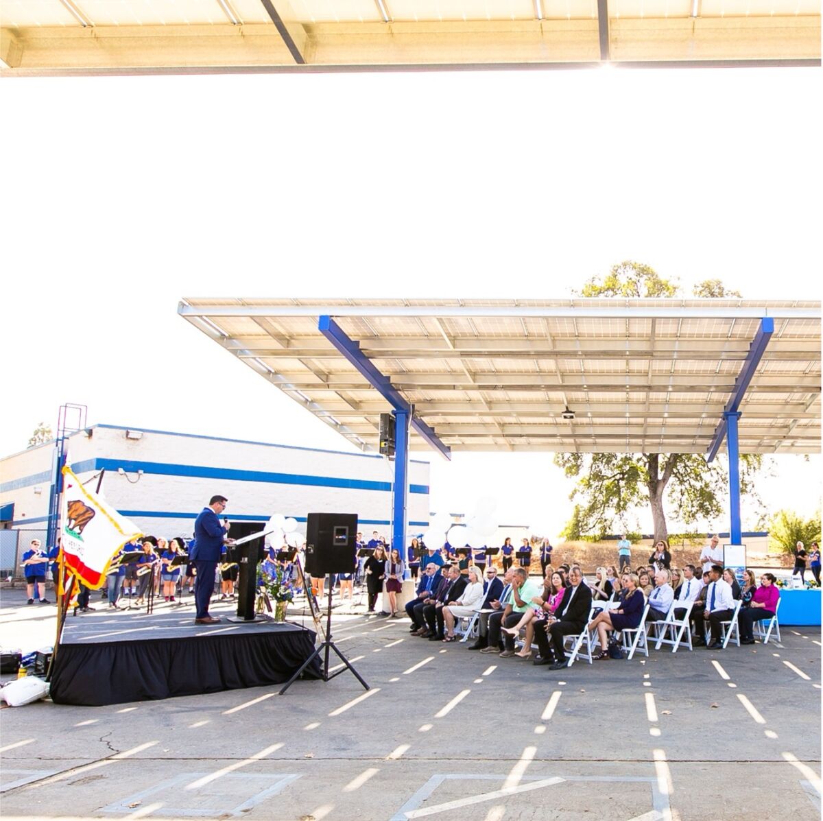 Community event at an El Dorado Union High School campus under solar panel shade structures.