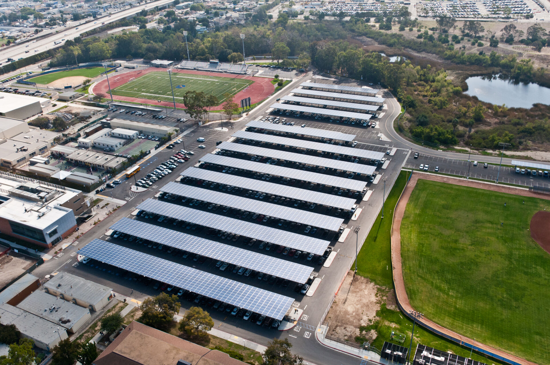 Aerial view of solar parking canopies at a Los Angeles Community College District campus, generating renewable energy while providing shaded parking and supporting district-wide energy modernization.